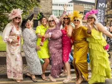 A group of ladies at Newcastle Racecourse in brightly coloured outfits