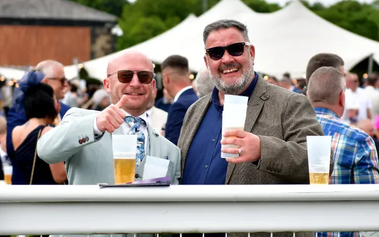 Two gents at Newcastle Races giving a thumbs up