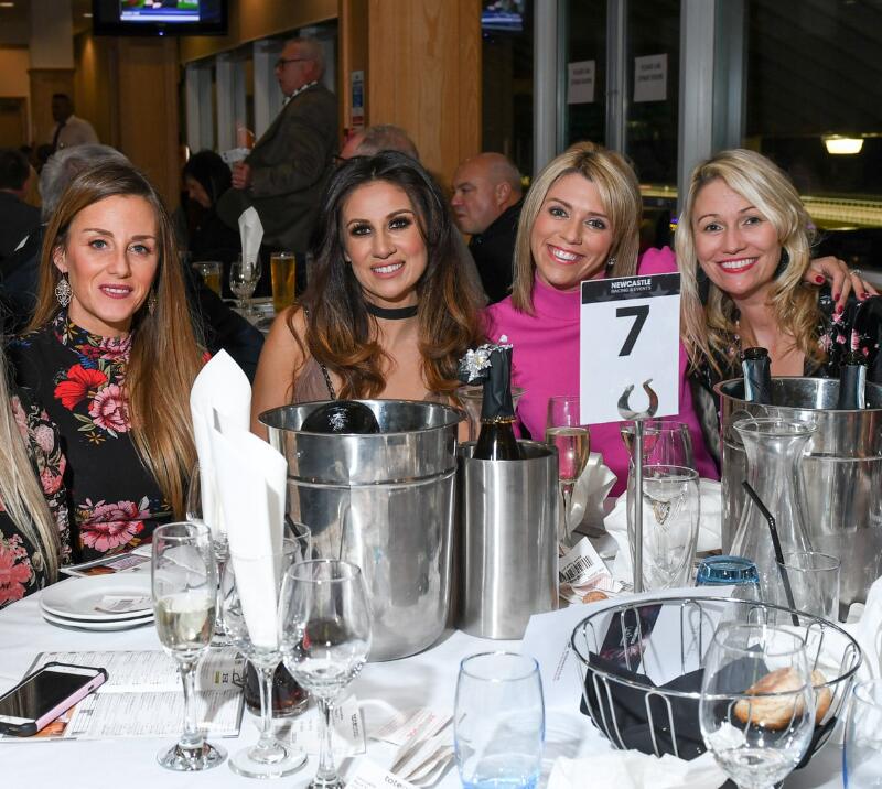 A group of women enjoying hospitality at a bonfire night event.