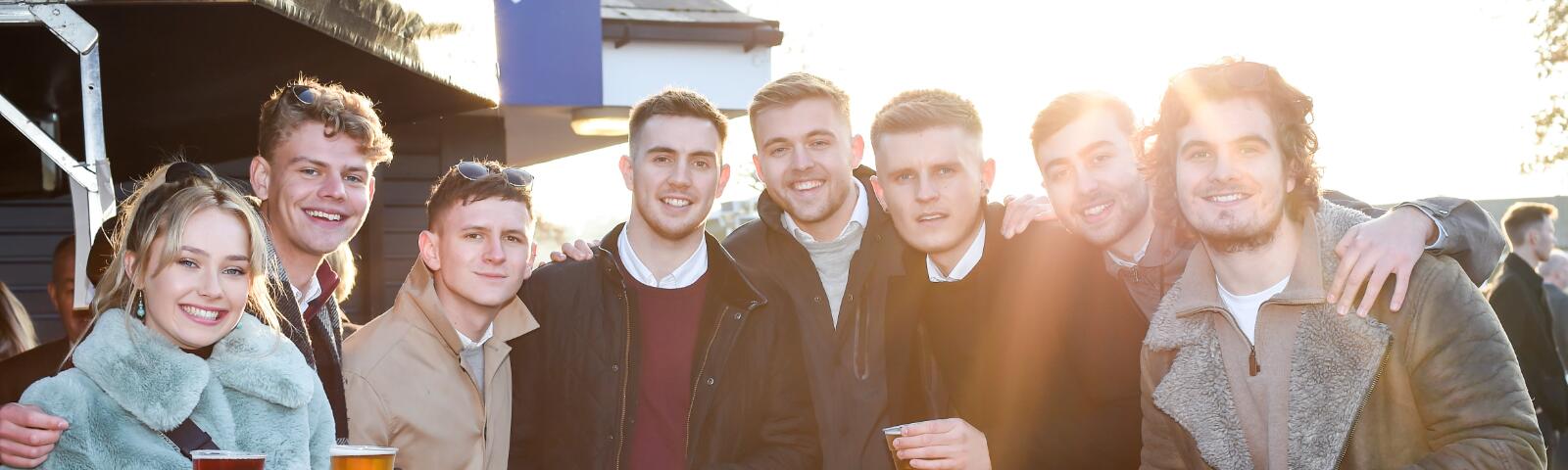A large group of friends enjoy the races at Newcastle