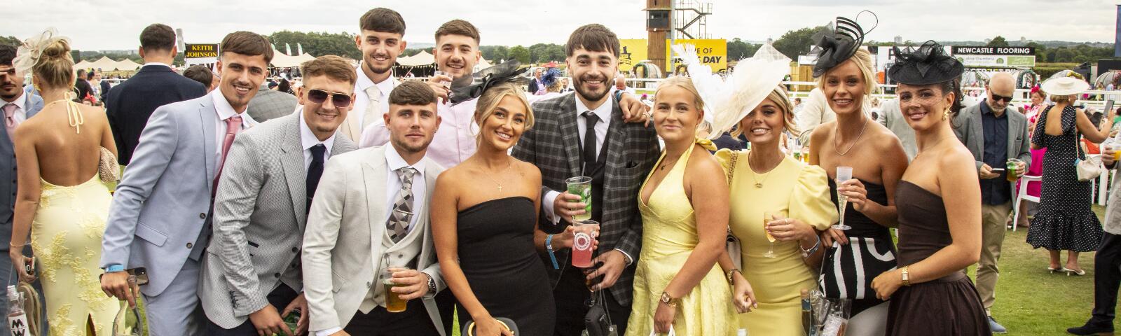 A large group of friends pose at Newcastle Races