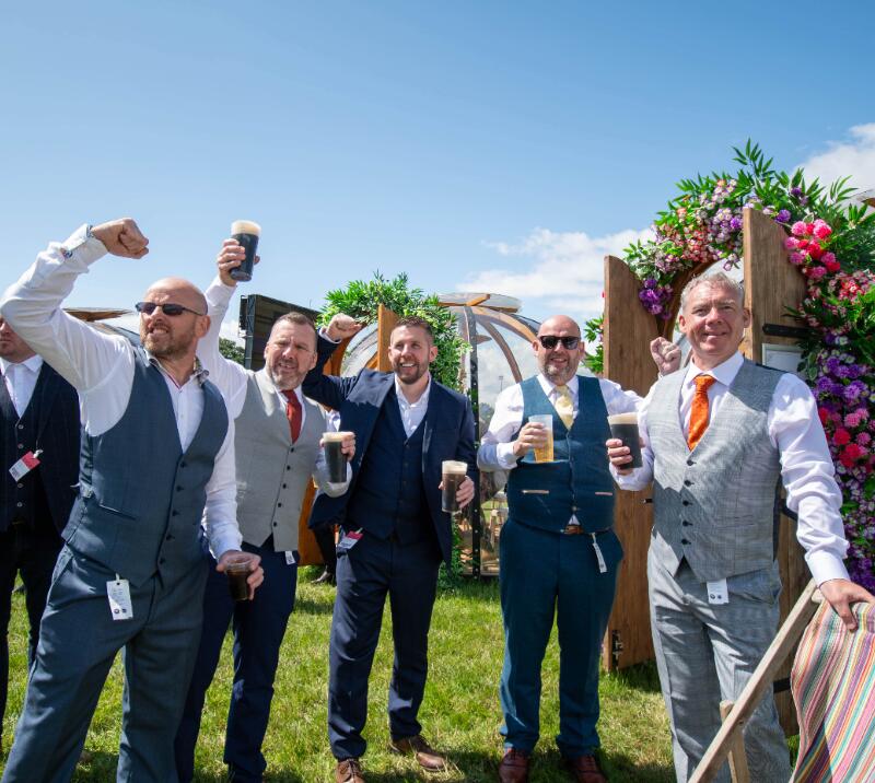 A group of very well dressed guys enjoy hospitality at Newcastle Races