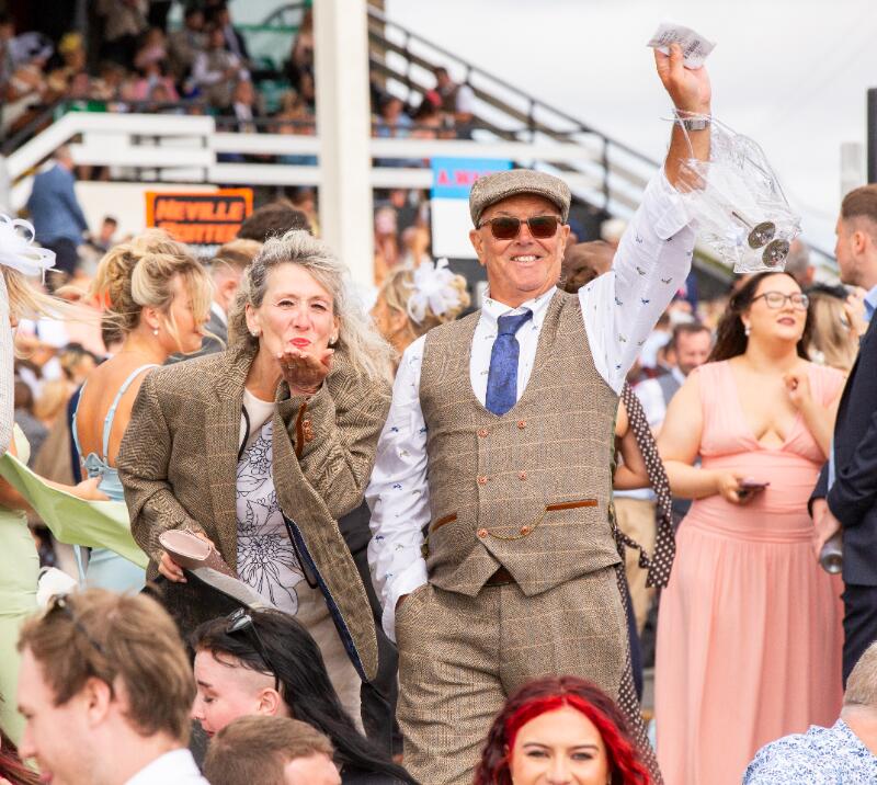 A couple posing for the camera at Newcastle Races