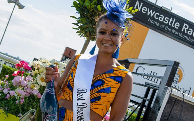 A stunningly dressed lady celebrates winning the best dressed prize at Ladies Day at Newcastle Racecourse.