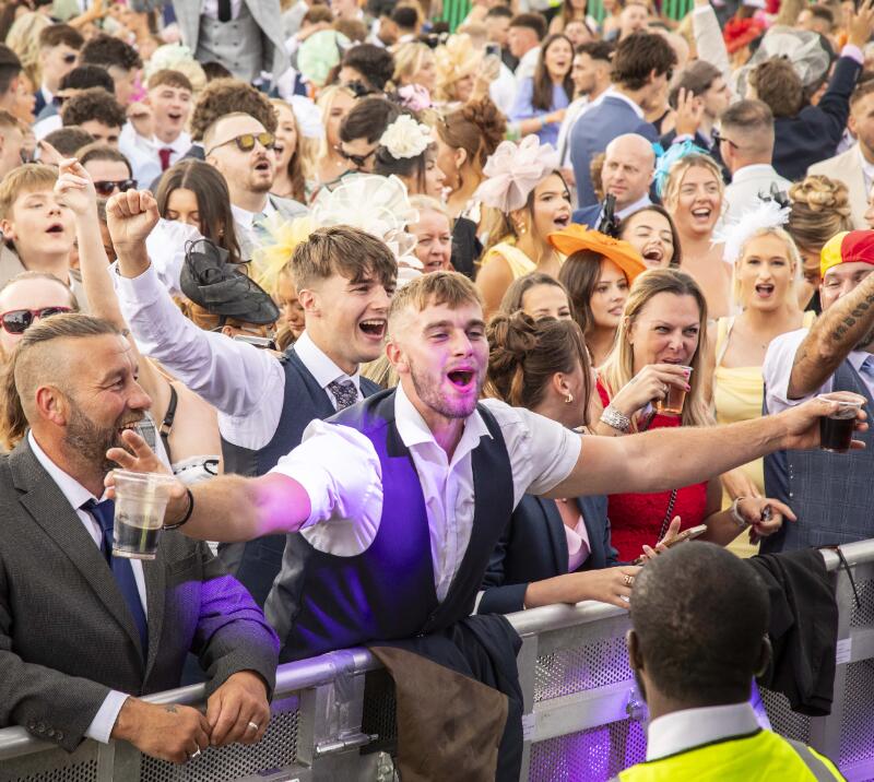 Racegoer singing and dancing to live entertainment at Newcastle