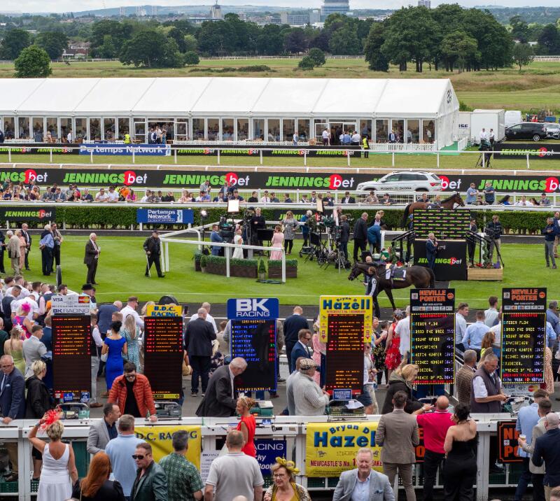 The line of bookmakers in front of the parade ring at Newcastle Racecourse