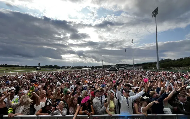 A large crowd enjoys live entertainment at Newcastle Races